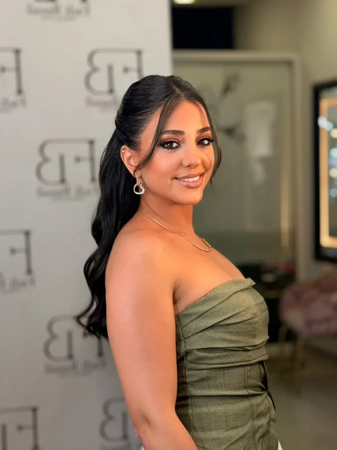 Warm evening makeup with a glossy lip and an olive dress