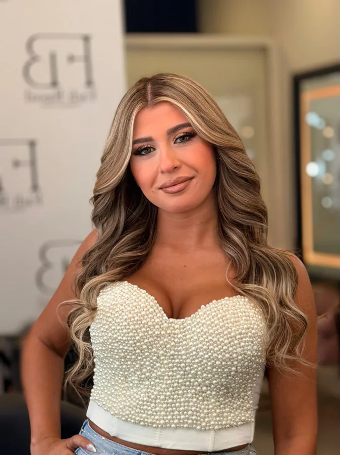 Defined eye makeup and soft nude lips with a pearl top