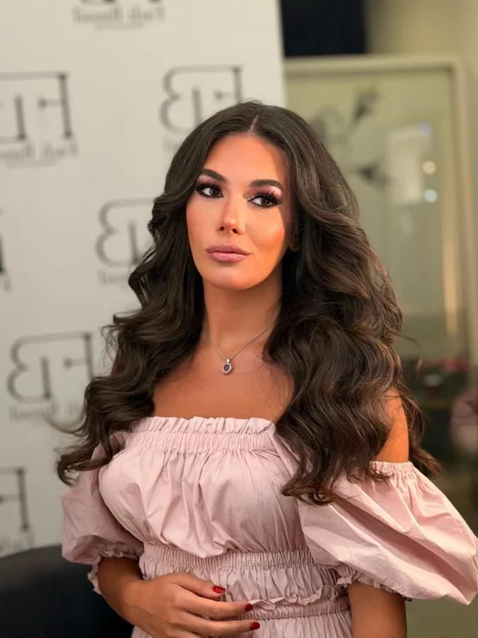 Smoky eye makeup and soft waves with a pink dress